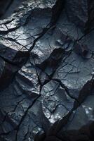 Dark rock formation showing cracks and texture, geology background photo