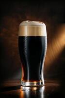Cold glass of dark beer with foam and cinnamon on dark background photo