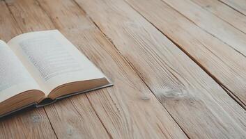 An open book lies on a wooden table, inviting reading and reflection. photo