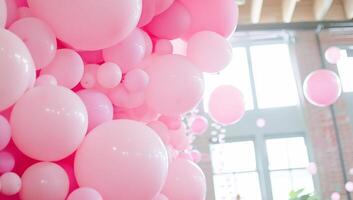 A vibrant display of pink balloons in a bright, airy space. photo