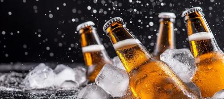 Beer bottles in ice with water falling on them photo