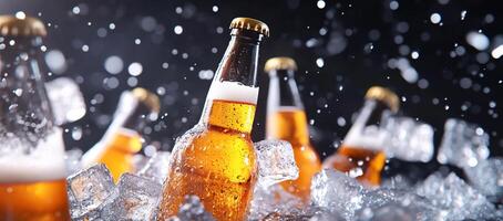 Beer bottles in ice with water falling on them photo