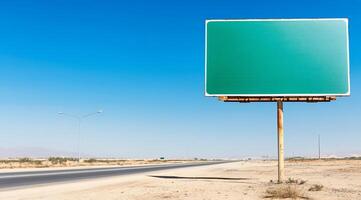 A blank billboard beside an empty road in a desert landscape. photo