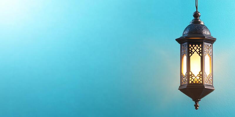 An old lamp hanging on a blue wall