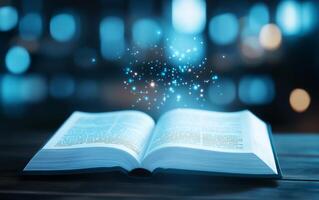 An open book with a magical glow and sparkling particles above it. photo