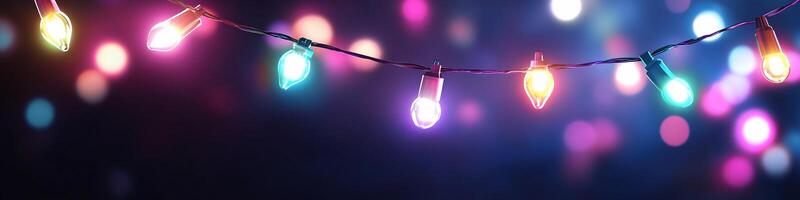 A string of colorful lights glowing against a blurred background. photo