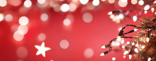 A festive scene with Christmas lights and a blurred red background. photo