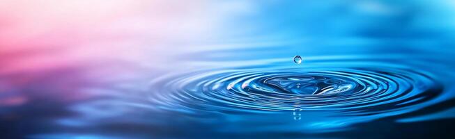 A close-up of a water droplet creating ripples in a serene environment. photo