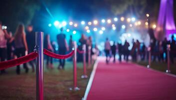 A red carpet event with people gathered under colorful lights. photo