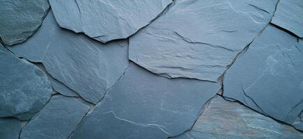 A close-up view of textured slate stone tiles arranged in a pattern. photo