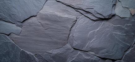 A close-up view of textured slate stone surface. photo