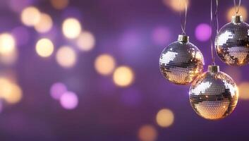Three disco balls hanging from strings on a purple background photo