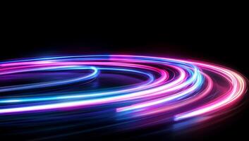Vibrant light trails swirl against a dark background, creating a dynamic effect. photo