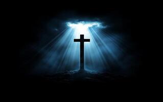 A silhouette of a cross illuminated by rays of light through clouds. photo