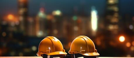 Two hard hats on a table with a city in the background photo