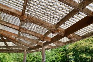 Selective focus of hanging rope mesh under roof. Creative idea for roof decoration. photo