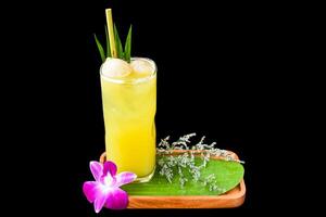 Lychee juice with slice of lychee fruit, with flowers isolated on black background photo