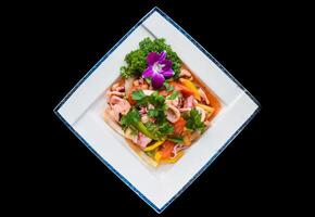 Vietnamese calamari with stewed vegetables and pineapple isolated on black background photo