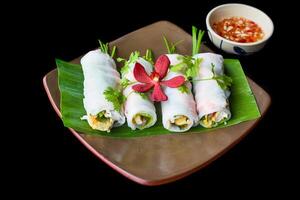 Vietnamese Pho spring roll with seafood, tofu, vegetables isolated on black background for a menu photo