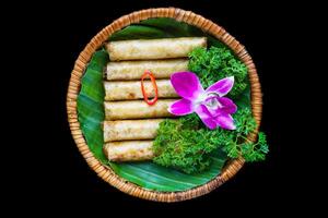 Traditional fried vietnamese spring rolls with pork, rice paper on black background top view photo