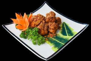 Vietnamese fried chicken meat on a white plate isolated for a menu photo