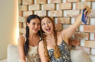 women portrait together with braids posing and taking a selfie photo