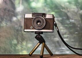 Vintage camera standing on a tripod photo
