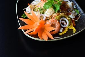 Thai salad made of shrimp and squid and onions isolated photo