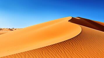A desert landscape with sand dunes and a blue sky photo