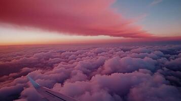 Aerial view of sunset clouds from airplane window. Vast expanse of fluffy cumulus clouds colored by the setting sun photo