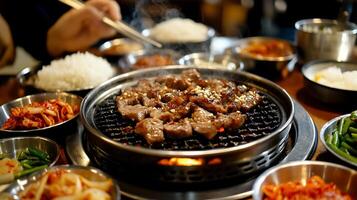Delicious grilled meat, rice, and various side dishes in a Korean BBQ restaurant photo