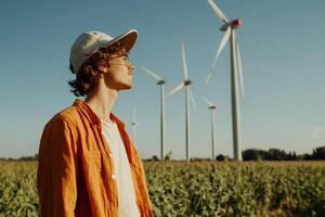 A man standing in front of wind turbines photo