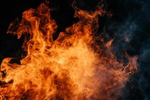 Fiery flames and smoky haze against a dark background. Intense orange and yellow flames mingle with grey smoke. A vibrant display of heat and movement photo