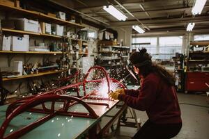 Woman welder in a workshop photo