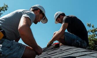 Two men working on a roof photo