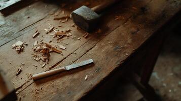Woodworking tools on a weathered workbench. Wood shavings and a chisel are scattered on a rustic wooden table photo