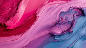 Vibrant paint swirls in a mix of pink, red, and blue tones photo