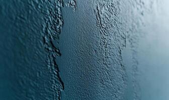 Textured teal wall with a rough, uneven surface photo