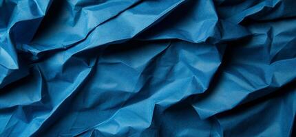 Deep blue fabric with dramatic folds and wrinkles photo