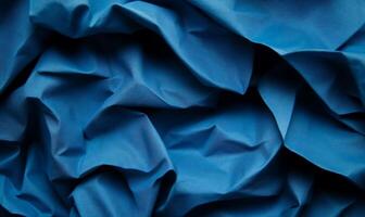 Deep blue fabric with dramatic folds and shadows photo