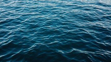 The surface of the ocean is blue and has ripples photo