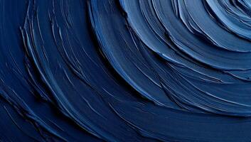 Deep blue swirls of thick paint create a mesmerizing circular texture photo