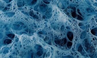 Abstract blue foam texture with intricate, organic shapes and air bubbles photo