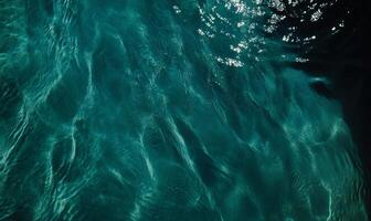 Underwater scene showing teal water with light patterns photo