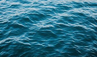 The surface of the ocean is blue and has ripples photo