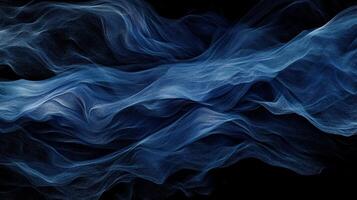 Abstract blue wave, flowing fabric-like texture on black background photo