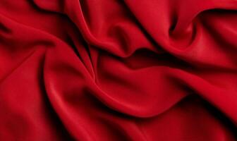 Rich crimson fabric, softly draped, showing elegant folds and texture photo