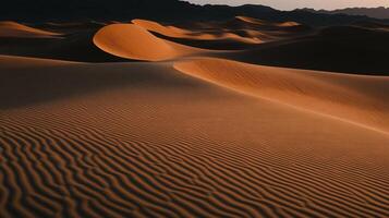Golden desert dunes at sunset, showing textured sand patterns photo