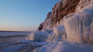 Frozen cliff face at sunset, icy formations cascading down photo