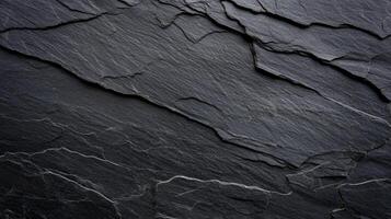 Dark gray slate texture with layered, rough surface photo